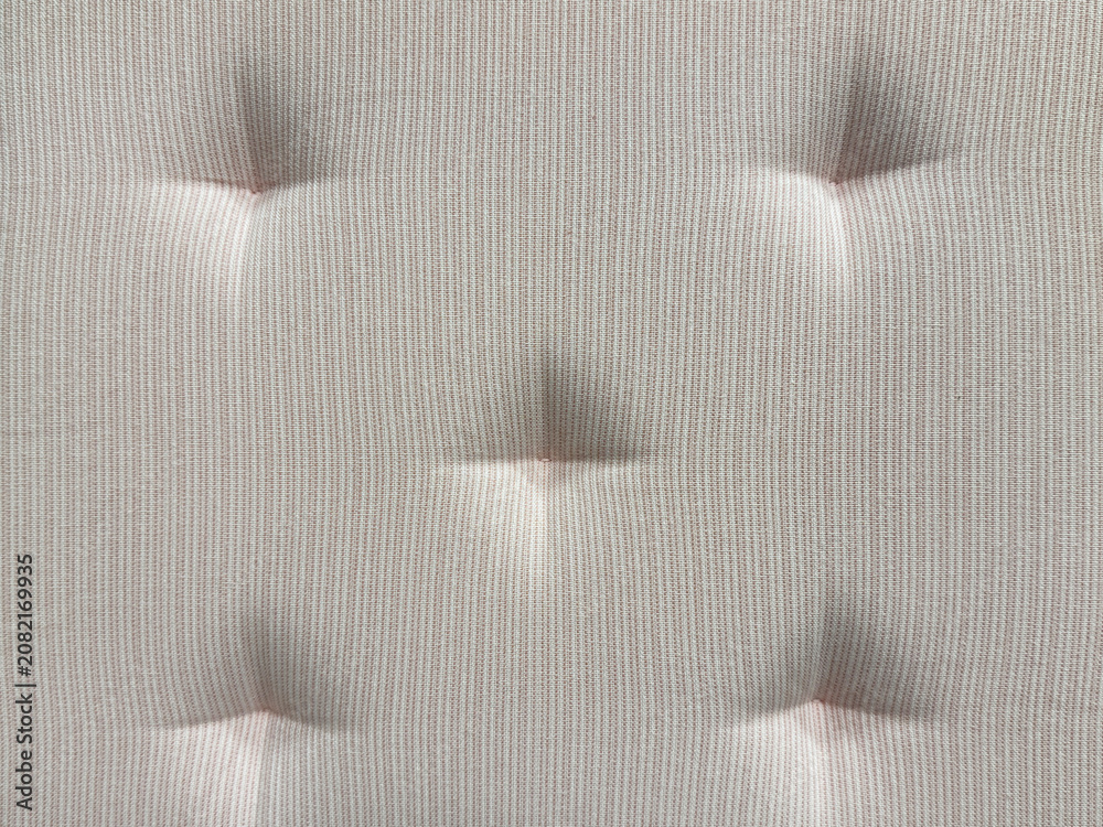Naklejka premium Close up of white stripes fabric with recessed embossed button. Suitable for sofa cushion backing, padded, and upholstered panel. Seamless background texture.