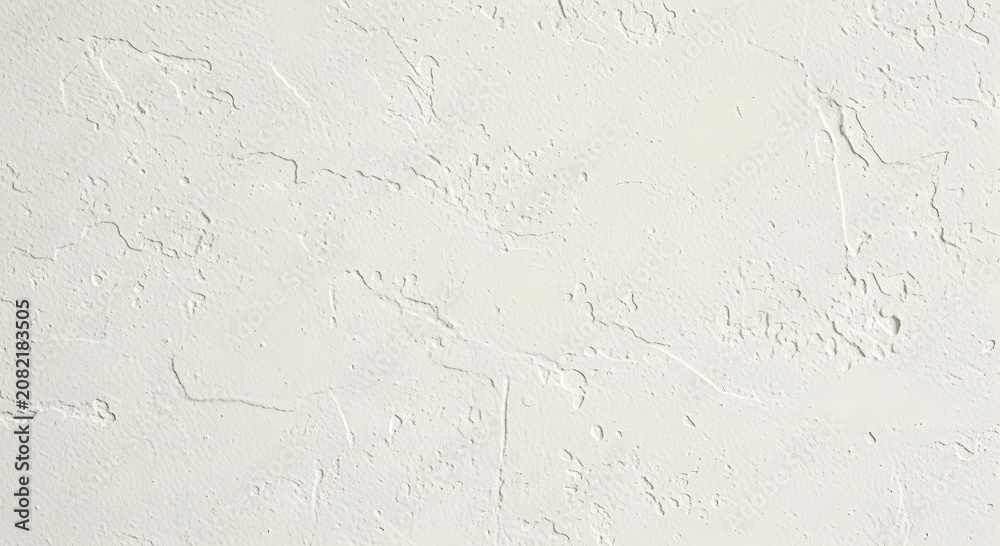 Fototapeta premium Close up of white plaster wall texture with rough surface and cracks