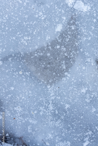 Texture and patterns of frozen ice with snow in winter scenery, background, texture