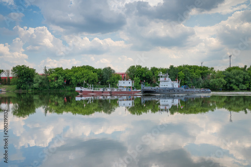 Pusher tug with barge on the river
