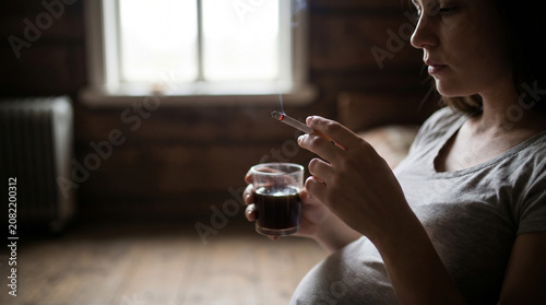 Pregnant Woman Smoking and Drinking Alcohol at Home During Pregnancy
