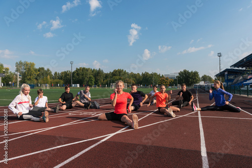 Group of children conducts a training session at the stadium. School gym trainings or athletics