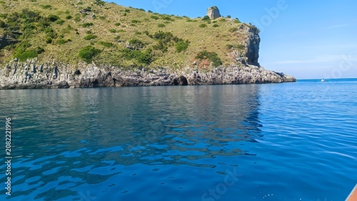 Vászonkép A serene coastal landscape featuring rugged cliffs, verdant vegetation, and calm, blue sea under a clear sky, perfect for relaxation and exploration