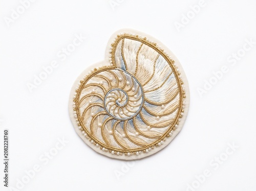 Intricate golden nautilus seashell with pearls embroidery art isolated on white background
