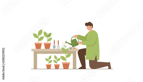 Young man caring for his potted plants by watering them with a green watering can on a garden table.