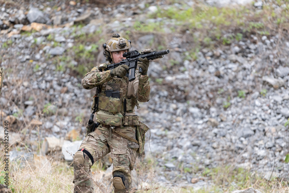 Fototapeta premium Military participate in a patrol in a rocky terrain