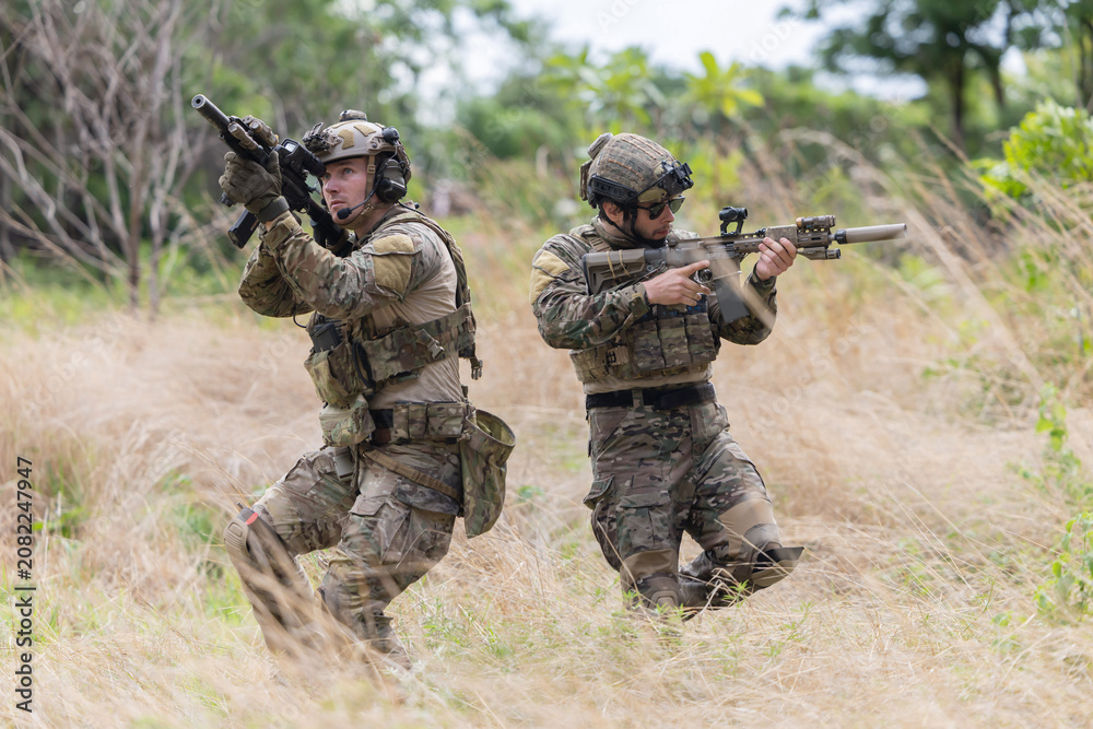 Fototapeta premium Military participate in a patrol in a rocky terrain
