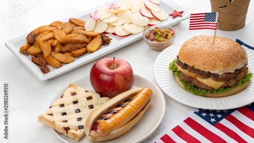 American independence day celebration meal with burger and hot dog fourth of july potato wedges united states outdoor dining snack time food spread summer party holiday meal tasty treat