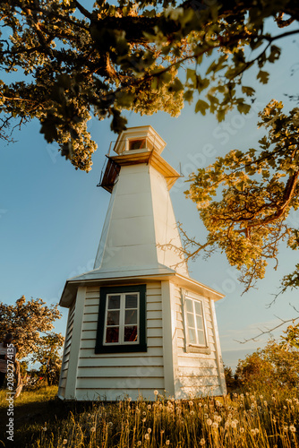Minimalist Swedish lighthouse against golden hour sky, Lake Vattern, Sweden.