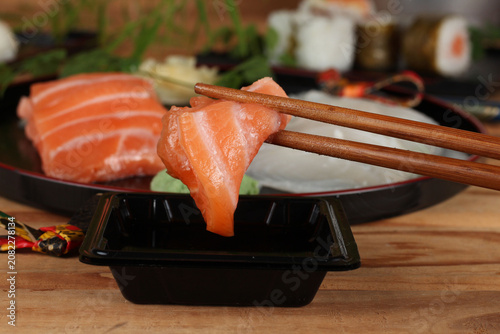 fresh sashimi and sushi served with soy sauce and wasabi