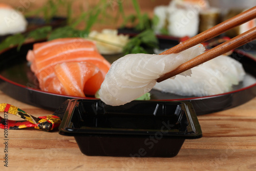 fresh sashimi and sushi served with soy sauce and wasabi