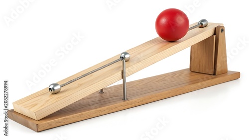Red sphere ball rolling down a wooden inclined plane science physics experiment