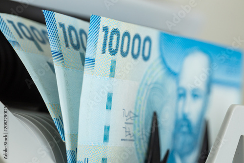 Obraz na plátně Chilean Peso banknotes stacked together inside currency counting machine
