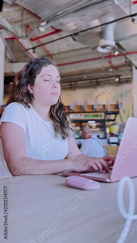 Young freelancer woman working remotely at coworking space