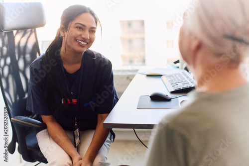 Smiling female doctor sharing good news with senior woman after her checkup