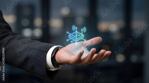 Wireless IoT Network Technology and Smart Connectivity Concept with Digital Chip Icon Above Businessman Hand