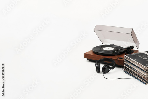 Turntable with headphones and vinyl records. Space for text.