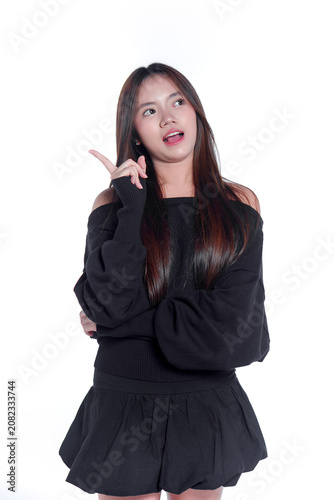 Portrait of an excited young Asian woman pointing upward with a bright idea
