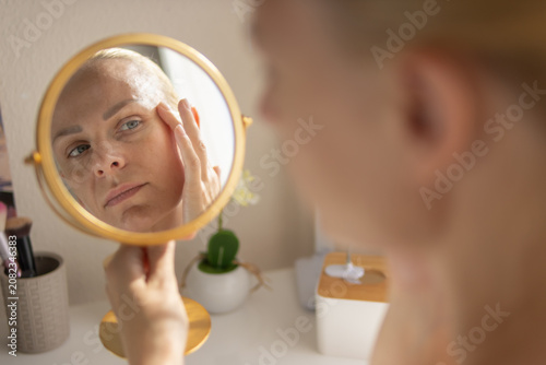 Fotografía Woman reflecting on her aging skin, inspecting delicate wrinkles around her eye