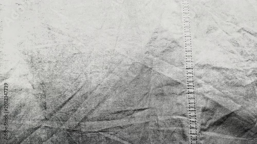 macro stitched seam on textured gray wrinkled linen fabric creates minimalist monochrome background