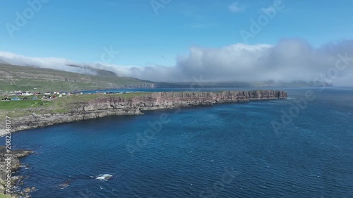 Drone shot of cliff edge on sunny day on the Faroe Islands