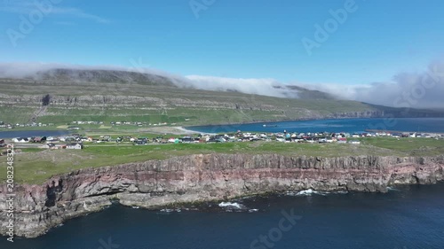 Drone shot of cliff edge on sunny day on the Faroe Islands