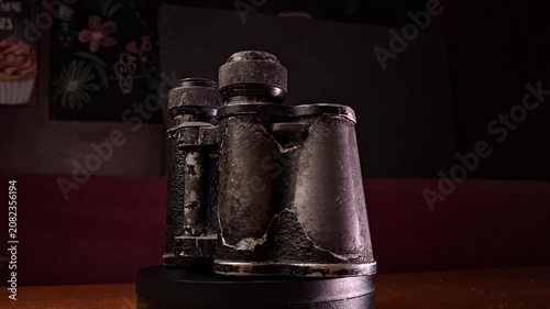 Vintage Military Binoculars Rotating on Dark Background