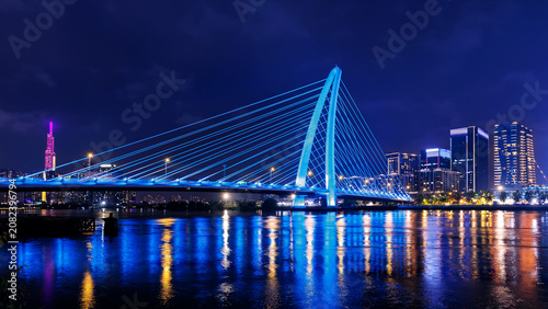 Bild auf Leinwand Night view of coastline with bridge and skyscrapers in Ho chi minh or Saigon cit