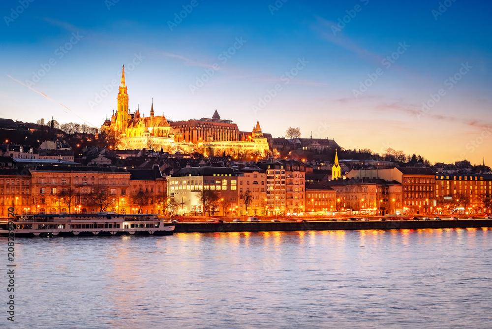 Fototapeta premium Sunset over Budapest skyline with Matthias Church, Fisherman's Bastion, and Danube River, Hungary
