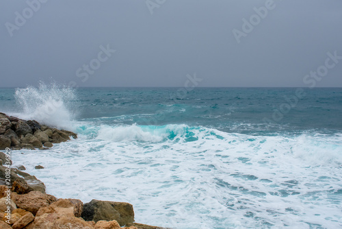 Waves Crushing into rocks on Coast in Paphos, Cyprus. Water hits shore of Mediterranean sea 
