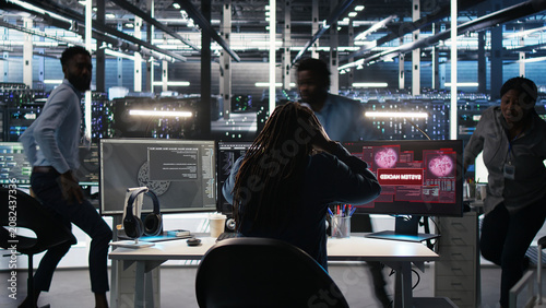 Schilderij op canvas Data center engineering team react to a malware alert on a computer, securing server equipment and protecting confidential data