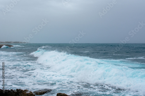 Waves Crushing into rocks on Coast in Paphos, Cyprus. Water hits shore of Mediterranean sea 