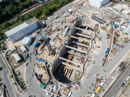 Aerial view of the Old Oak Common station HS2 construction site, featuring deep excavation pits, heavy machinery, cranes, and temporary site structures in London, England, United Kingdom.