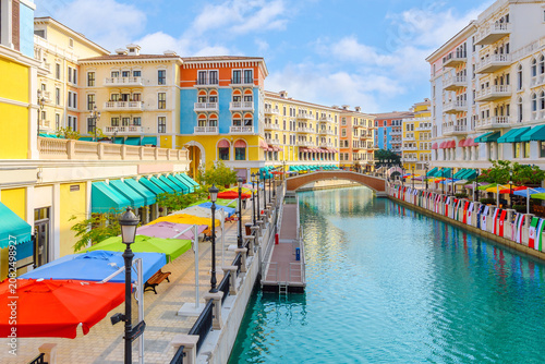 The brightly colored Qanat Quartier in The Pearl Island, Doha, Qatar, a district designed to emulate Venetian architecture with waterways and bridges.