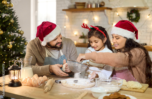 Bilde på lerret Parents and daughter bake Christmas cookies, happy family cooking at home in kitchen