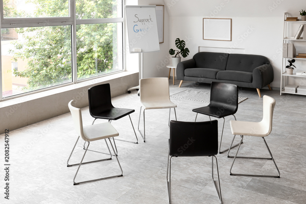 Fototapeta premium Empty support group meeting room with chairs arranged in circle