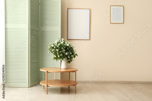 Fotografie Minimalist interior with wooden table and flower vase
