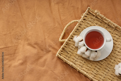 Tray with cup of tea and co...