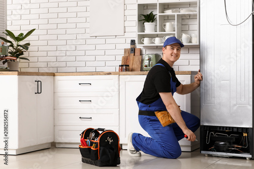 Happy male worker with tool...