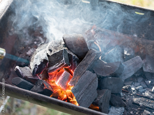 Фотография Lighting Charcoal Briquettes for Barbecue