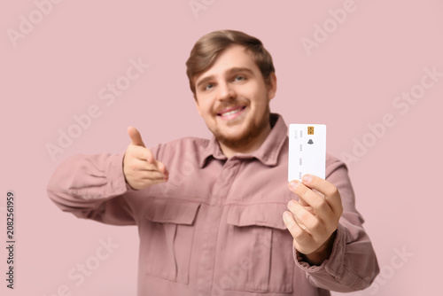 Smiling young man pointing ...
