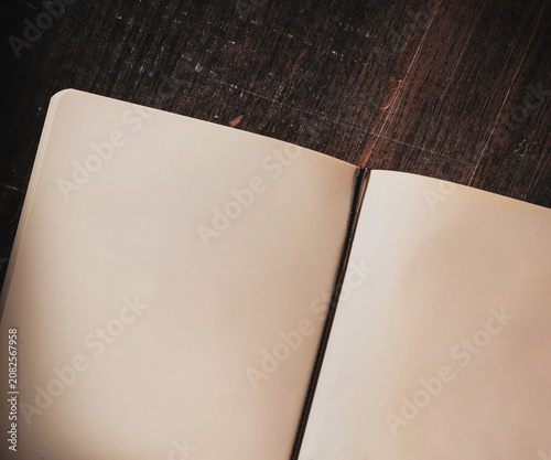 Open Notebook on Rustic Wooden Table with Blank Pages for Writing Ideas