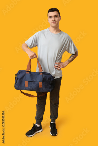 Young man with sports bag o...