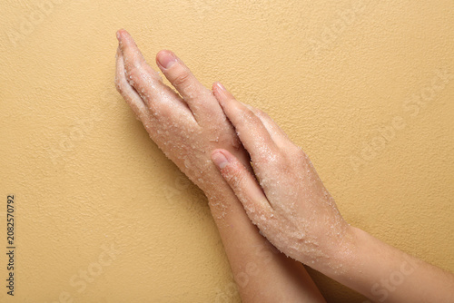 Woman applying body scrub o...