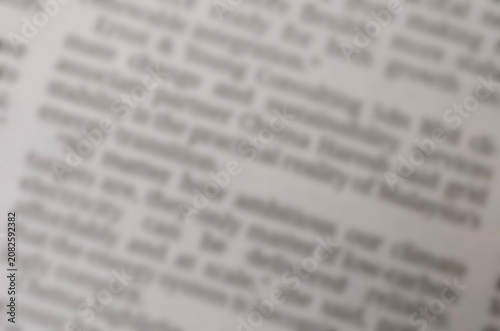 Blurred newspaper article text layout representing daily press release and information flow