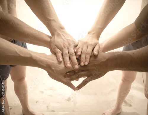 Close-up of hands united, forming a circle symbolizing cooperation. Hands, arms together