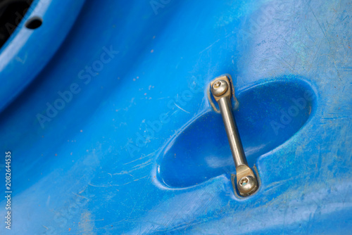 Canvas Print Blue plastic surface with metal handle attached, showing scratches and wear, sug