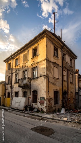 Dilapidated building exterior with weathered facade and cloudy sky