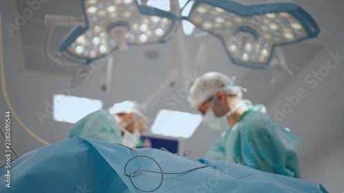 Surgical surgery health care team operating in operation room. Surgeons in hospital performs surgical procedures. Team of doctors processing surgical operation in modern emergency.