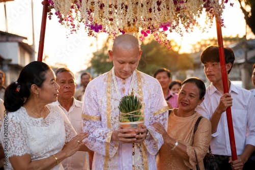 Thai monk ordination daily monastic life at sunset with family gathering and floral canopy in buddhist ceremony